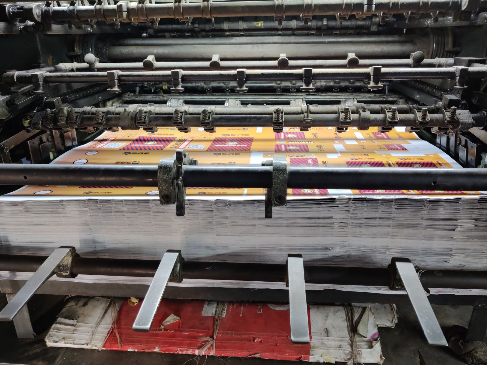 Paper stock stacked high at the delivery end of the press